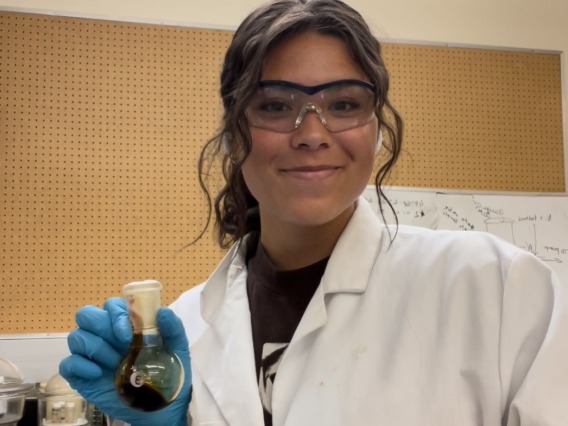 Maddie Tibayan holding a chemical in a vial