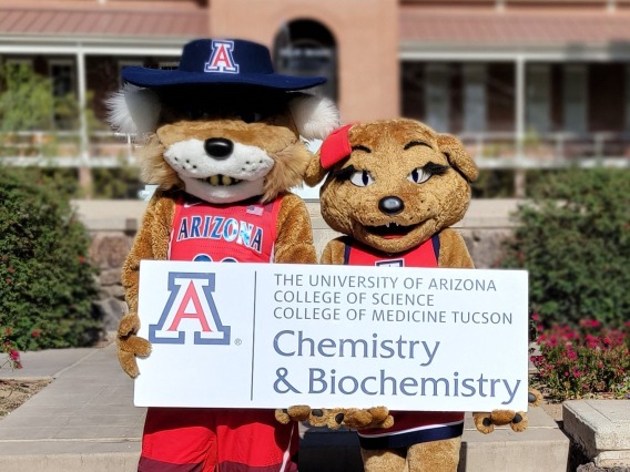 Wilbur and Wilma holding a Chemistry & Biochemistry sign