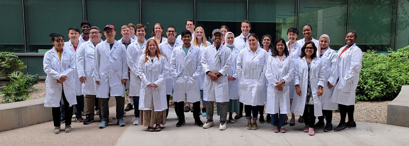 2023 1st year graduate students in white lab coats.