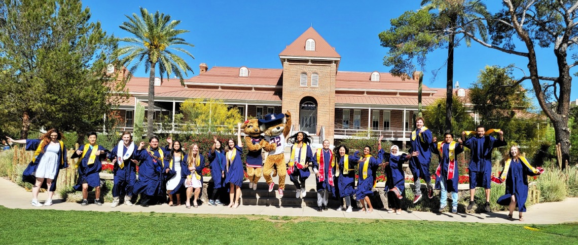 Class of 2023 group photo while jumping with Wilbur and Wilma