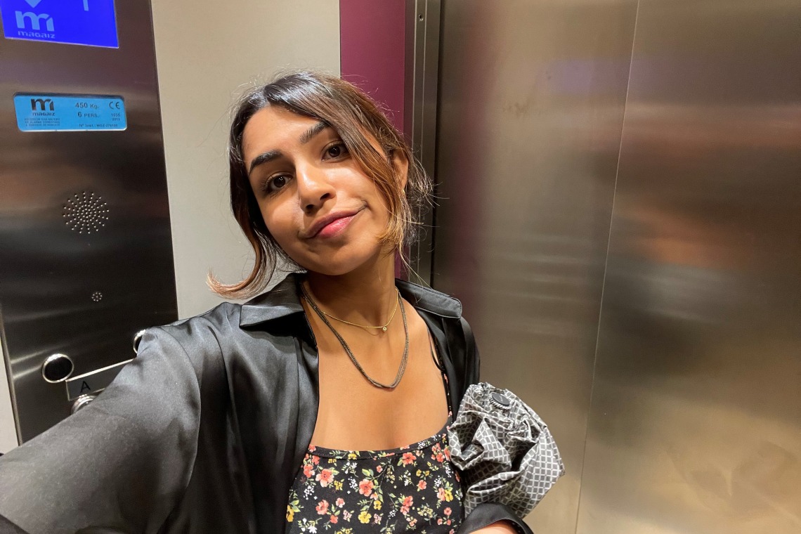 Grace Parekh taking a selfie in an elevator