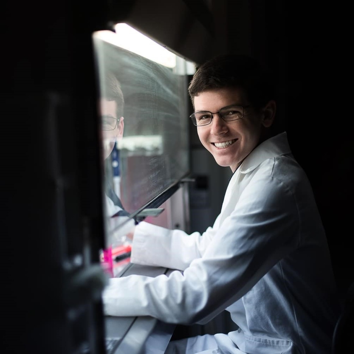 photo of student Jason Kronenfeld in a lab smiling